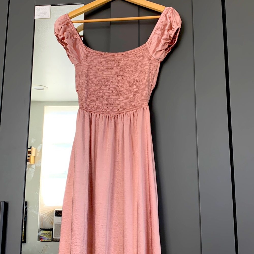 It’s NOMB pretty pink dress with two slits on each side.